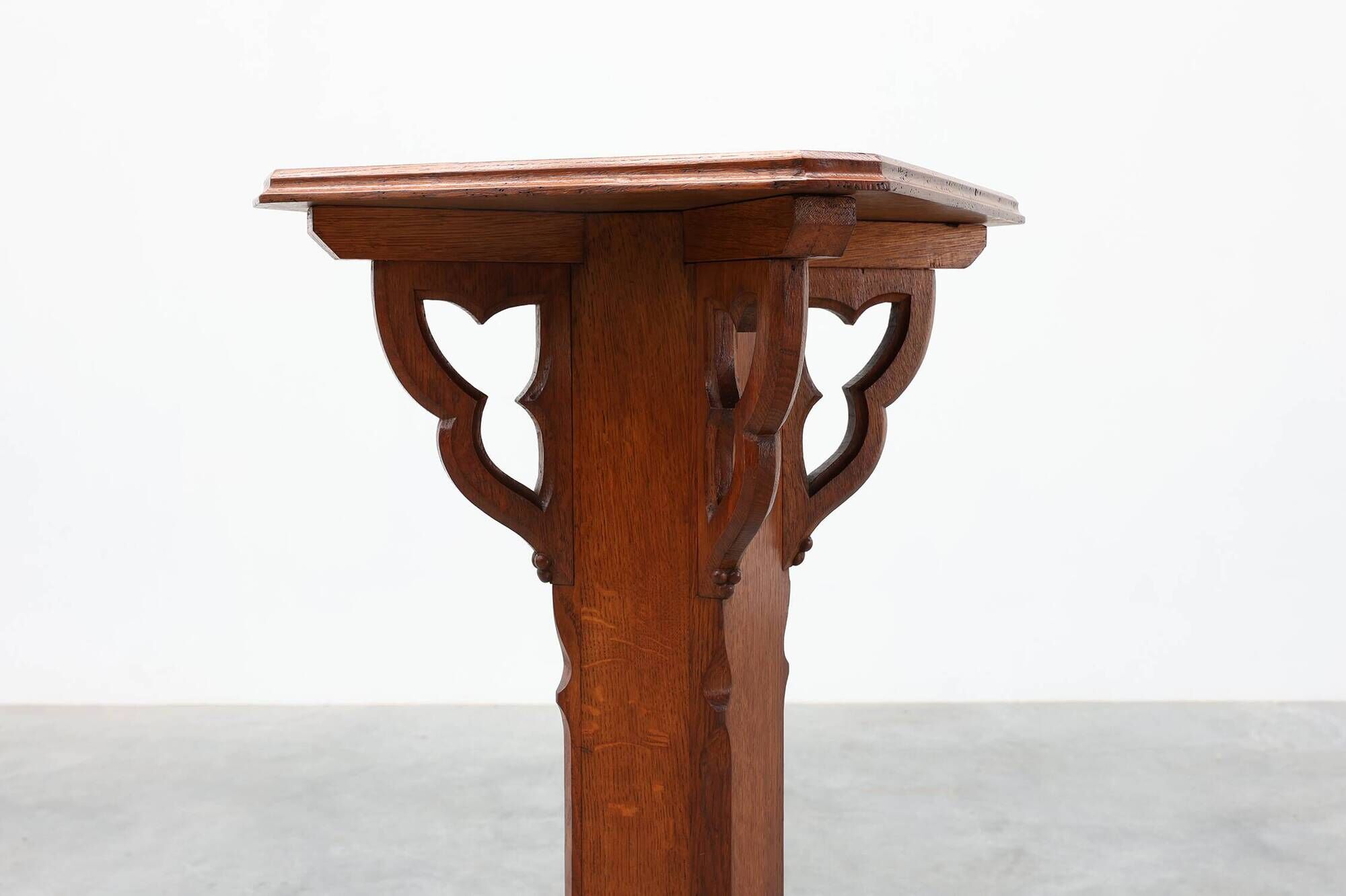 Art Deco oak pedestal with pierced brackets and cross base, Belgium 1920s