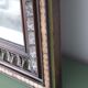 Antique mirror with a carved and painted wooden frame
