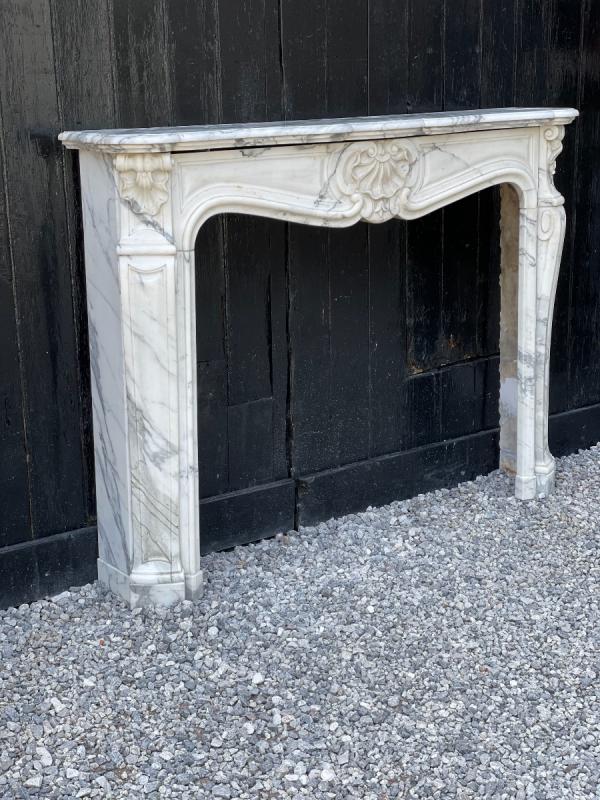 Louis XV style fireplace in white Carrara marble arabescato