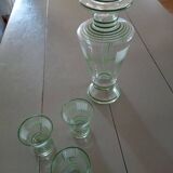 Carafe of green-striped liquor and its three glasses