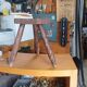 Vintage tripod stool in carved solid wood.