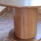 Round table with a central pedestal, light wood, 1990s.