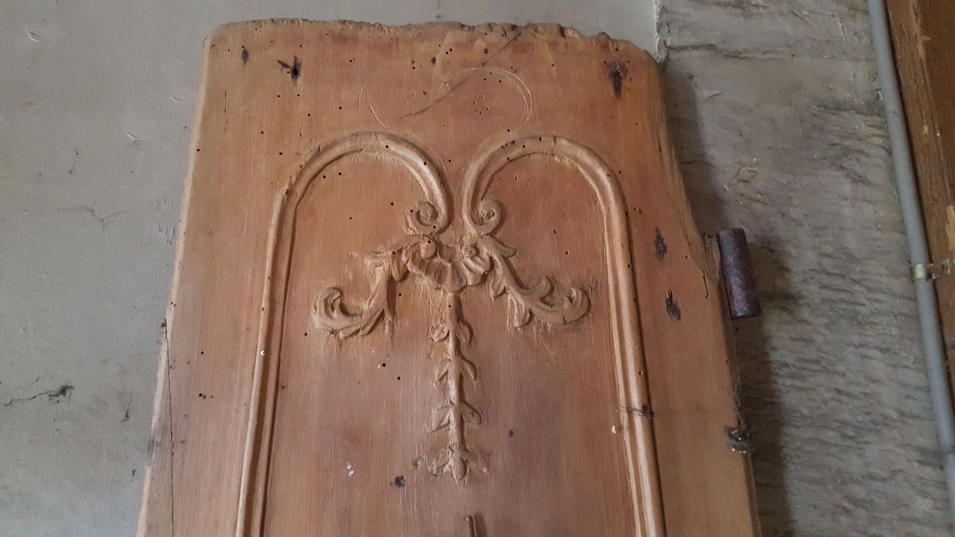 Wearing old 18th century decoration carved with flowers and foliage