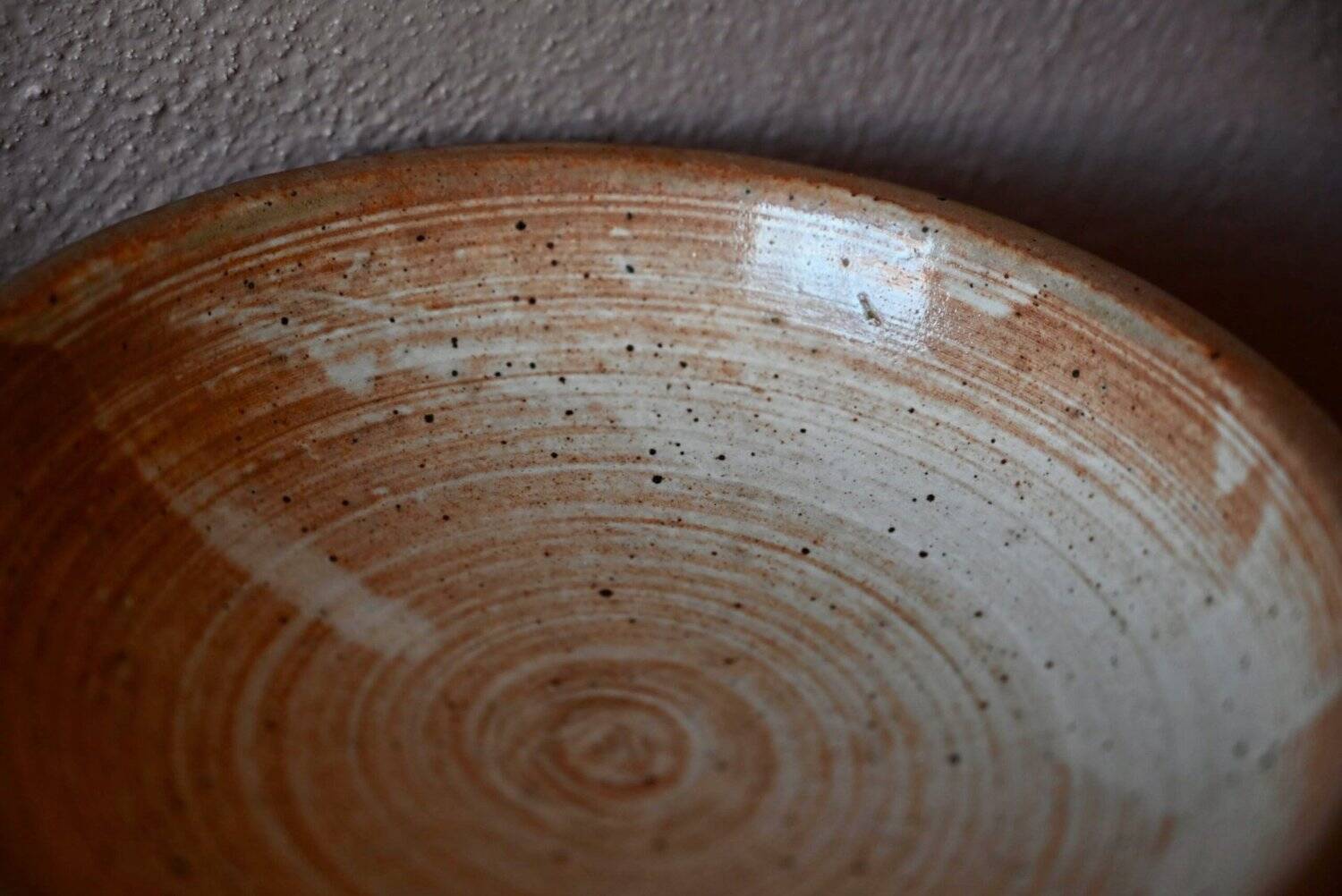 Set of 10 turned stoneware plates, pyritised and glazed, wabi-sabi brutalist.