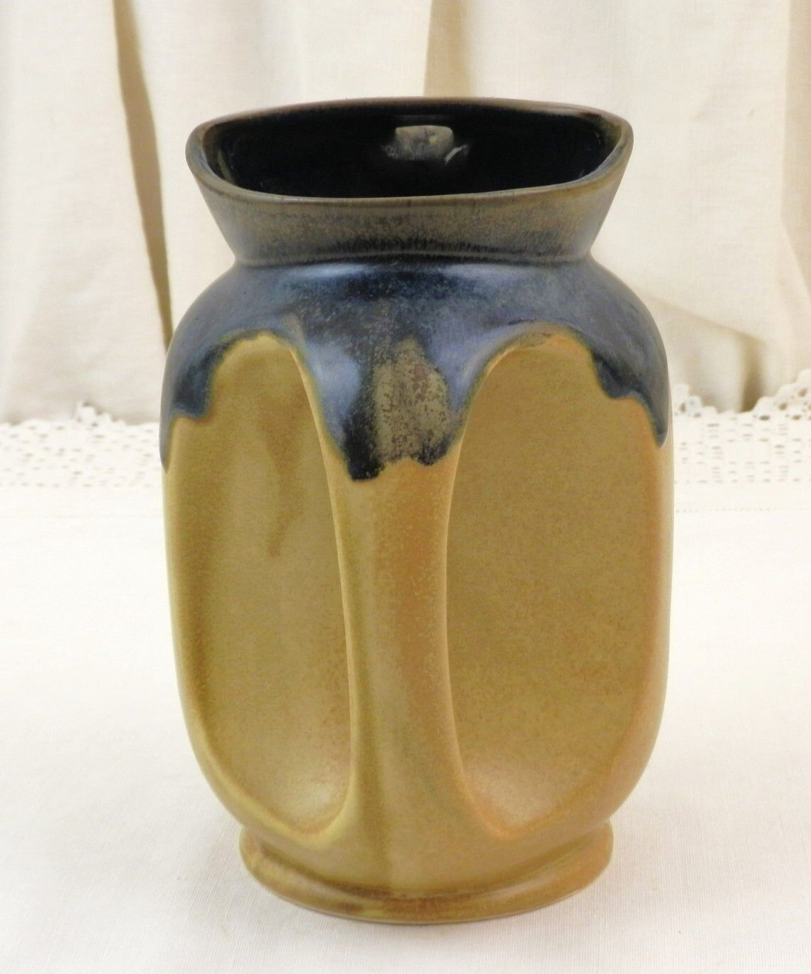 Vintage art deco water pitcher with drippy dark blue glaze.