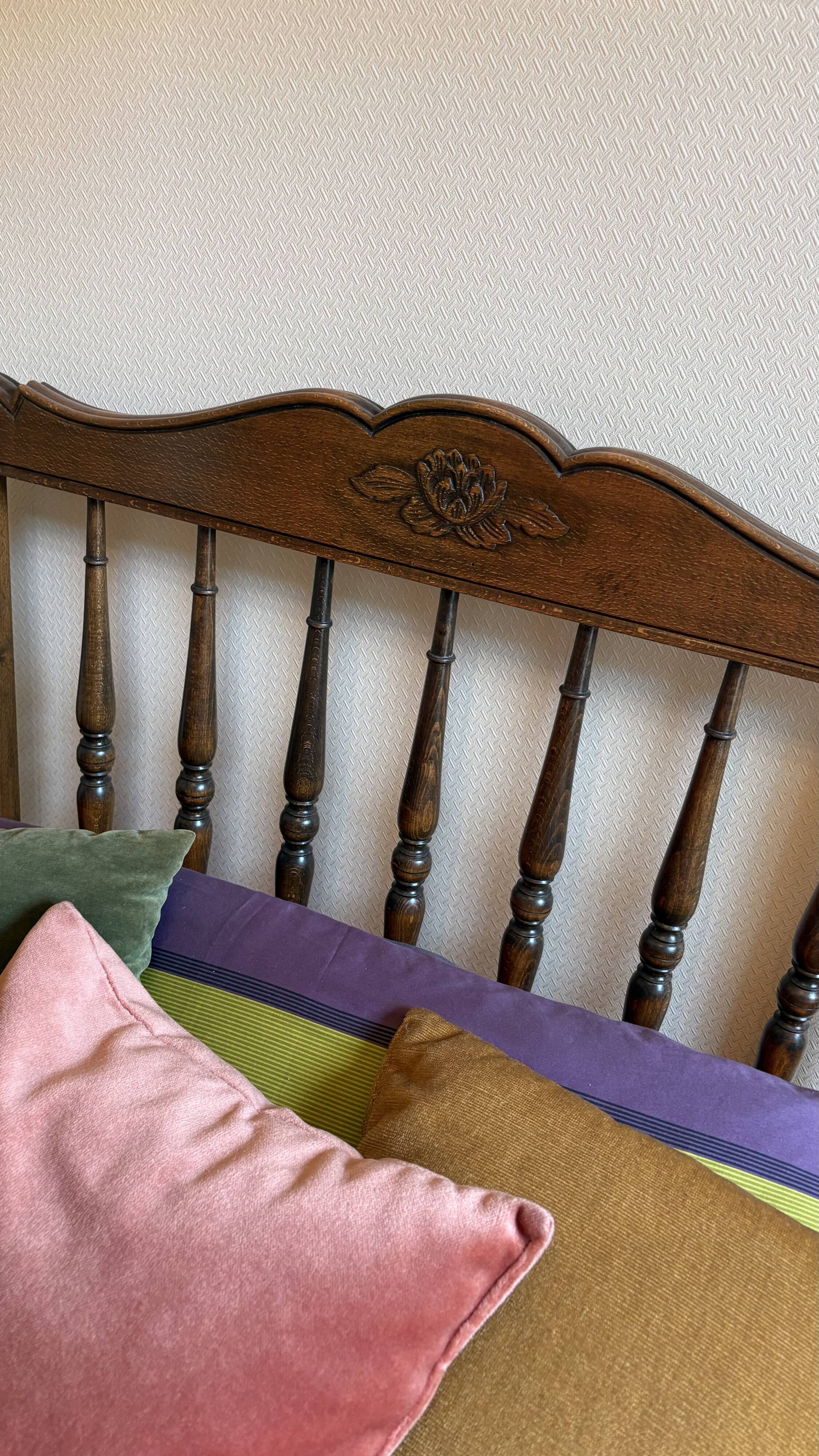 1 bed with a wooden frame and mattress