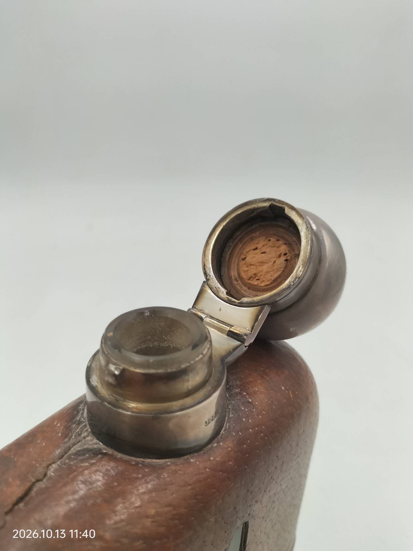 Silver-plated metal flask with leather and glass