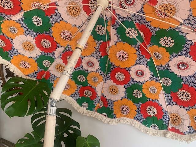 Large floral tilting beach umbrella with cotton fringes, 1960