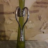 Large decanter with large glass neck and silver metal handle.