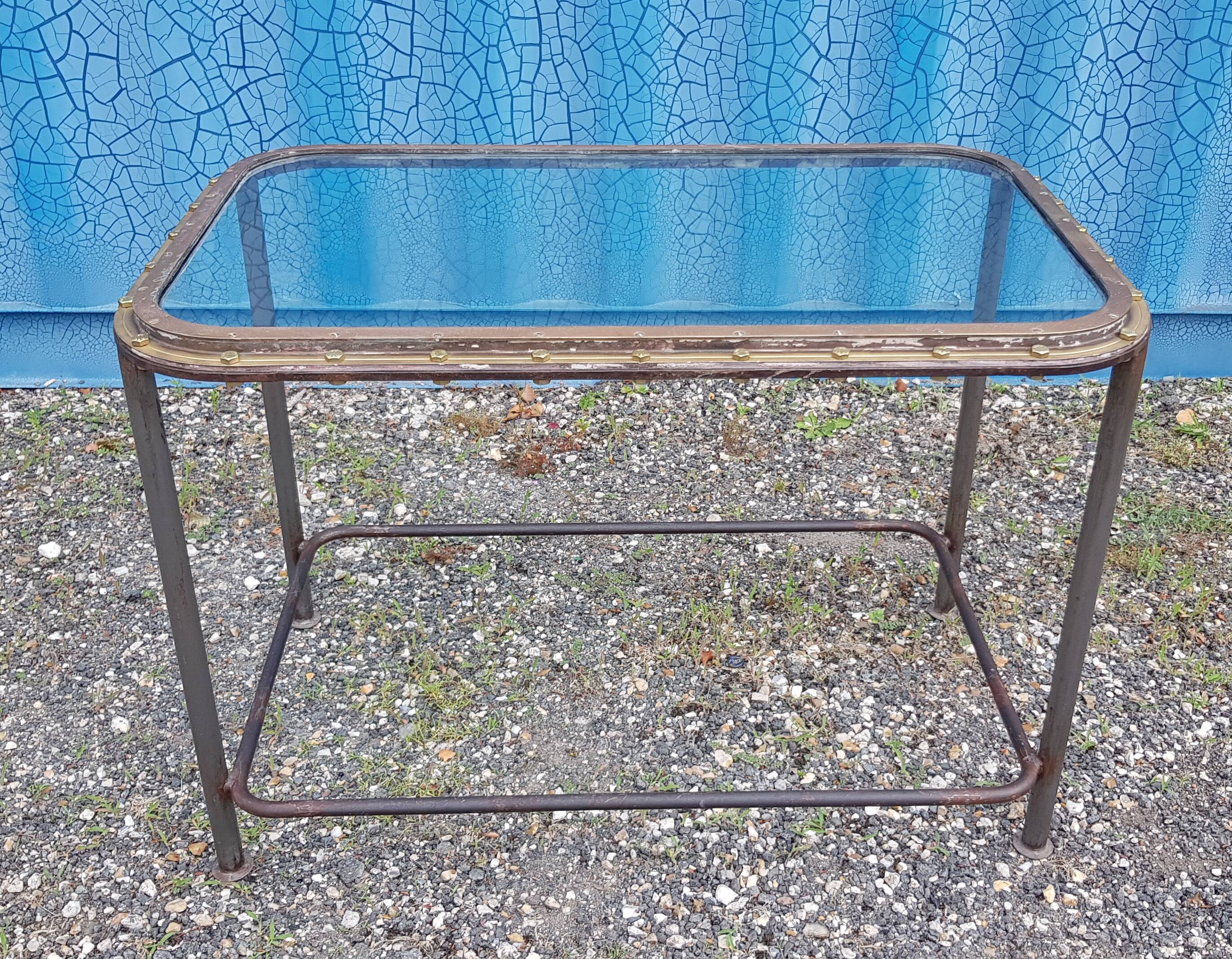 Table with an old ship porthole in brass and a metal base / 110 x 70 x 76 cm