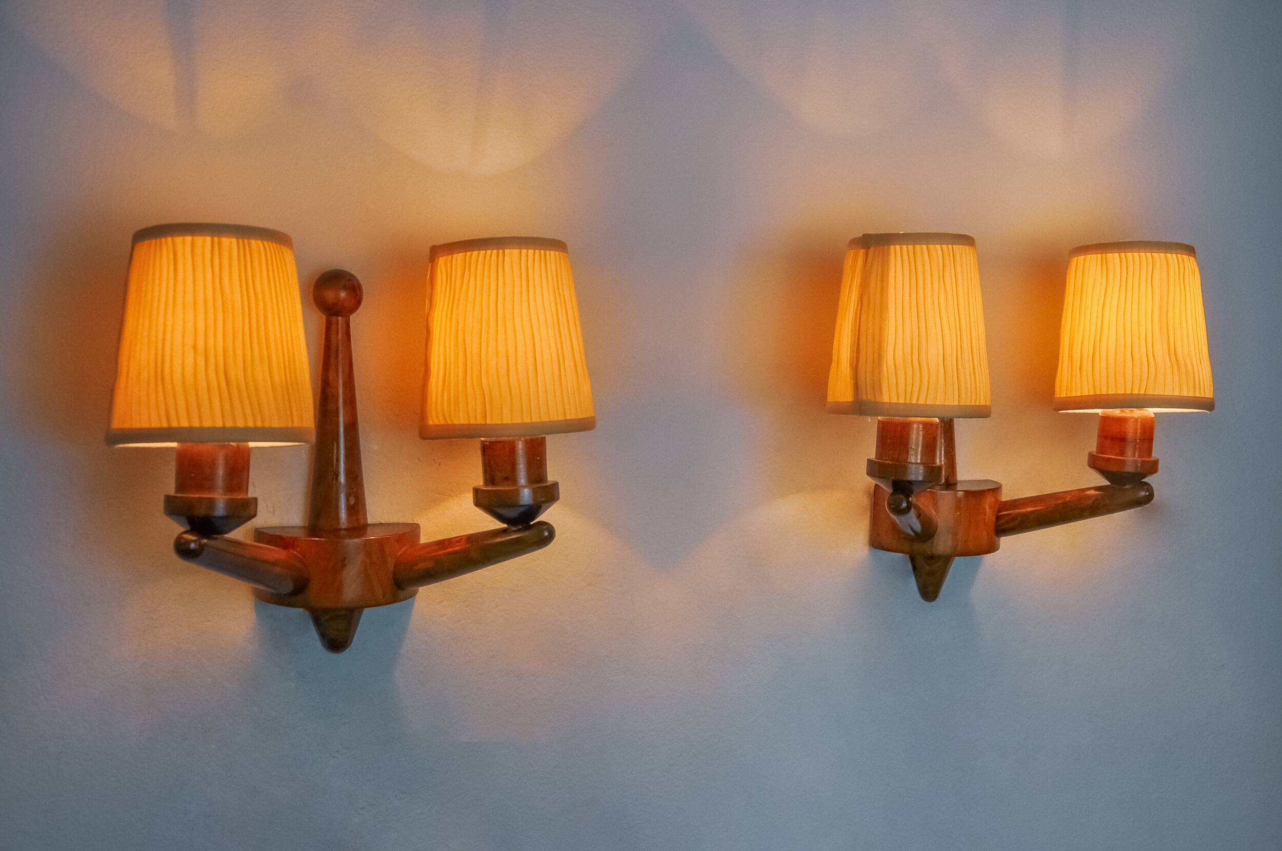 Pair of two-armed art deco "ball" wall lights, carved wood, France, 1960