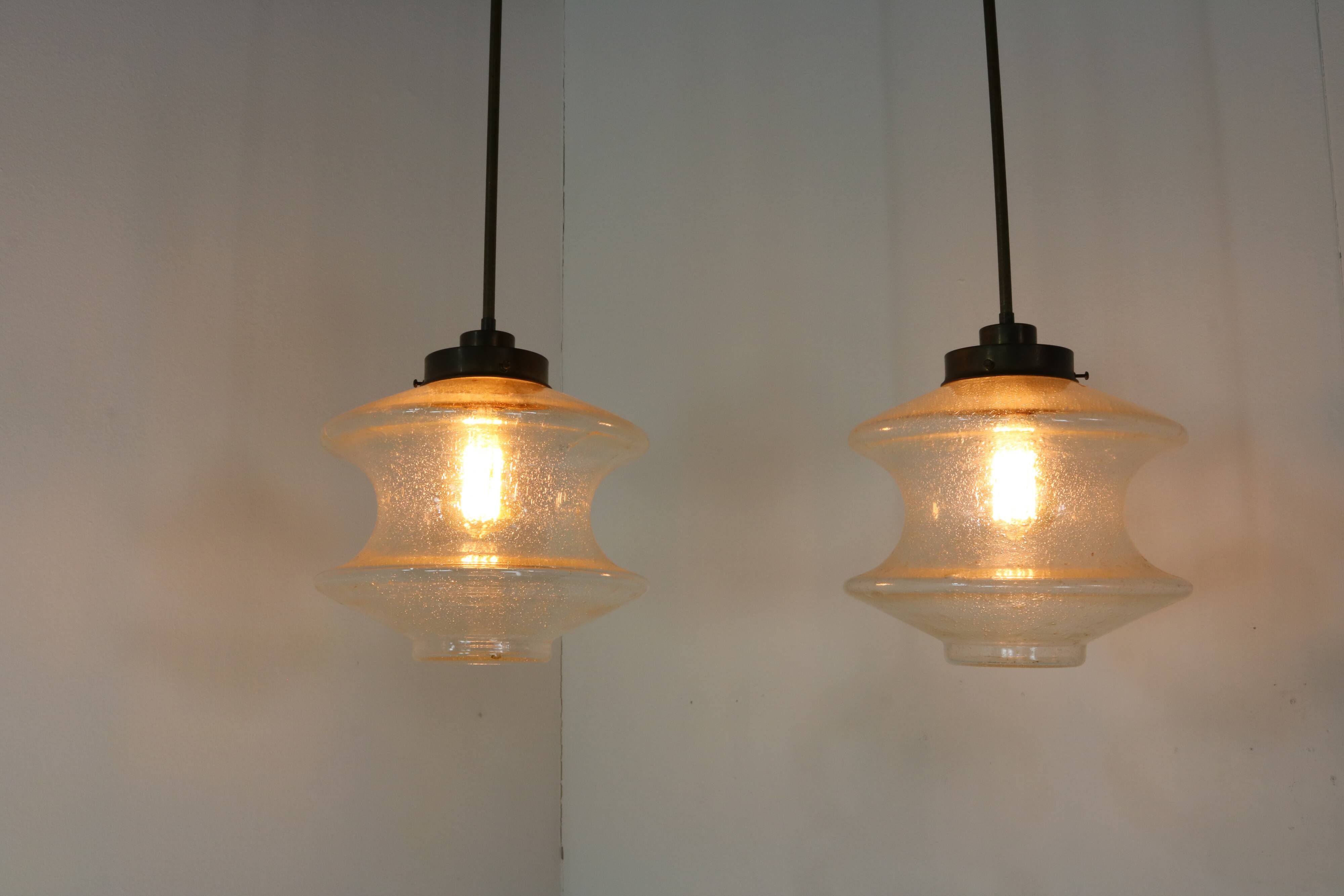 Set of two glass pendant lighting designed by Raak Holland