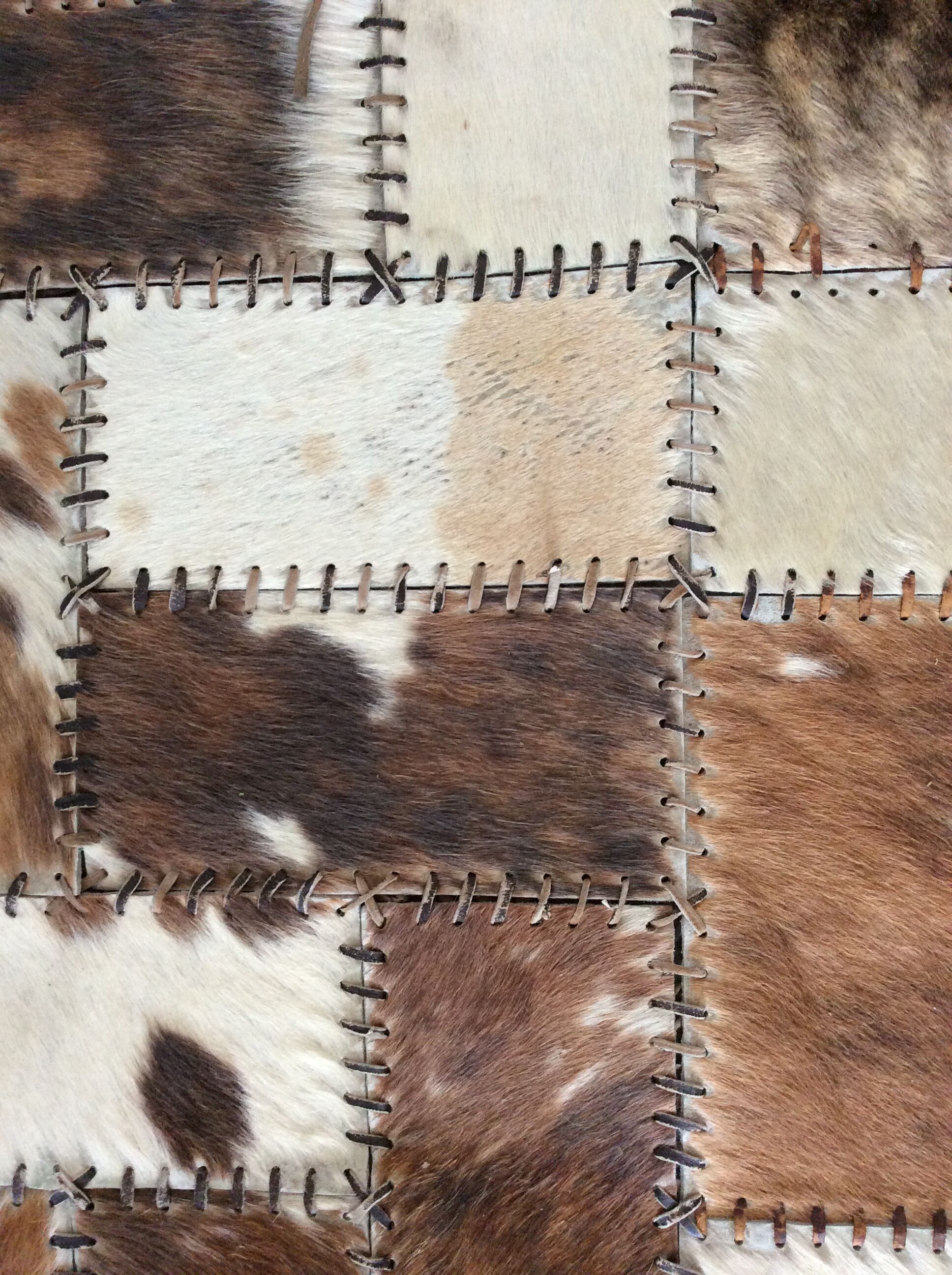 Patchwork carpet in cowhide 164x105cm from the 70s