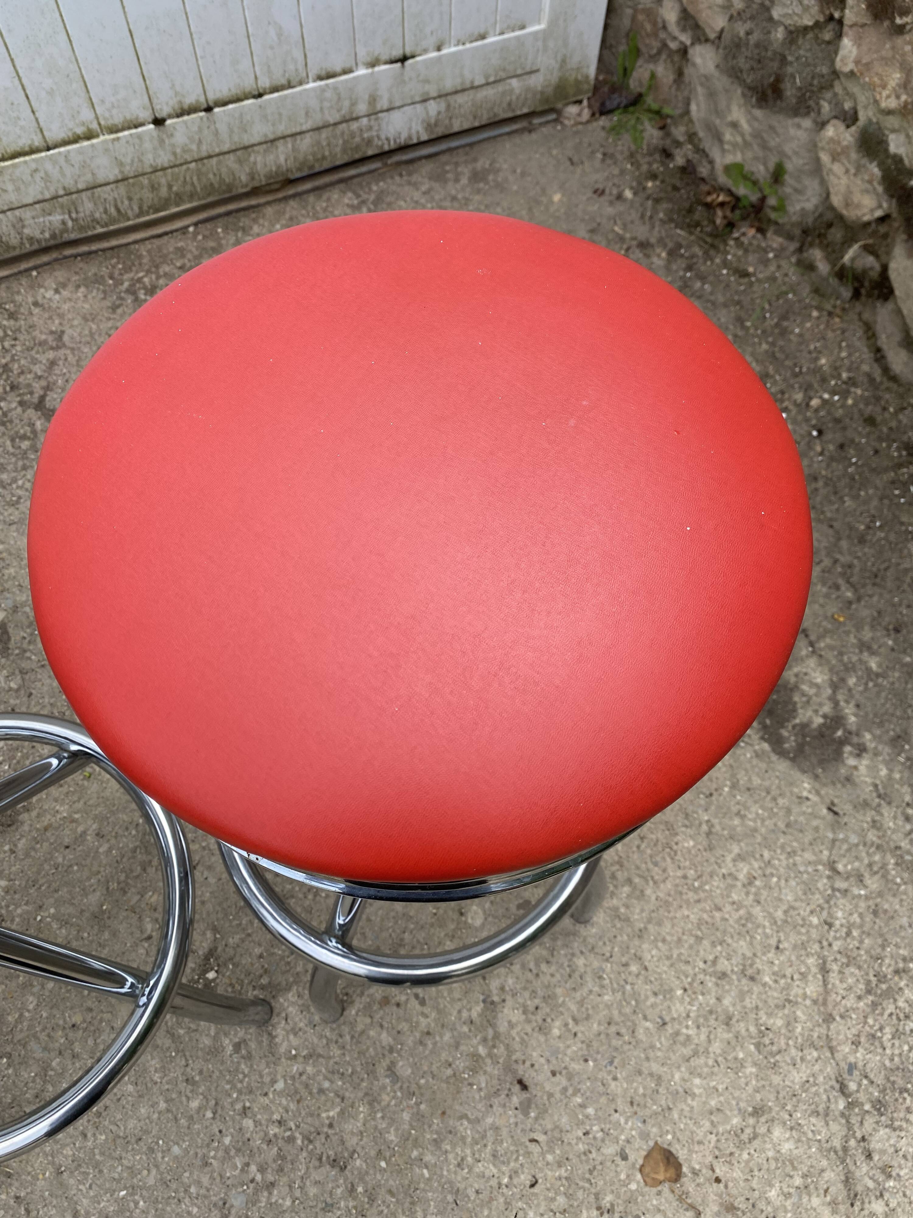 Set of 5 vintage swivel bar stools in blue, red, orange, and yellow.