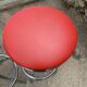 Set of 5 vintage swivel bar stools in blue, red, orange, and yellow.