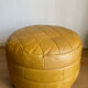 2 poufs moutarde patchwork en cuir de Sède