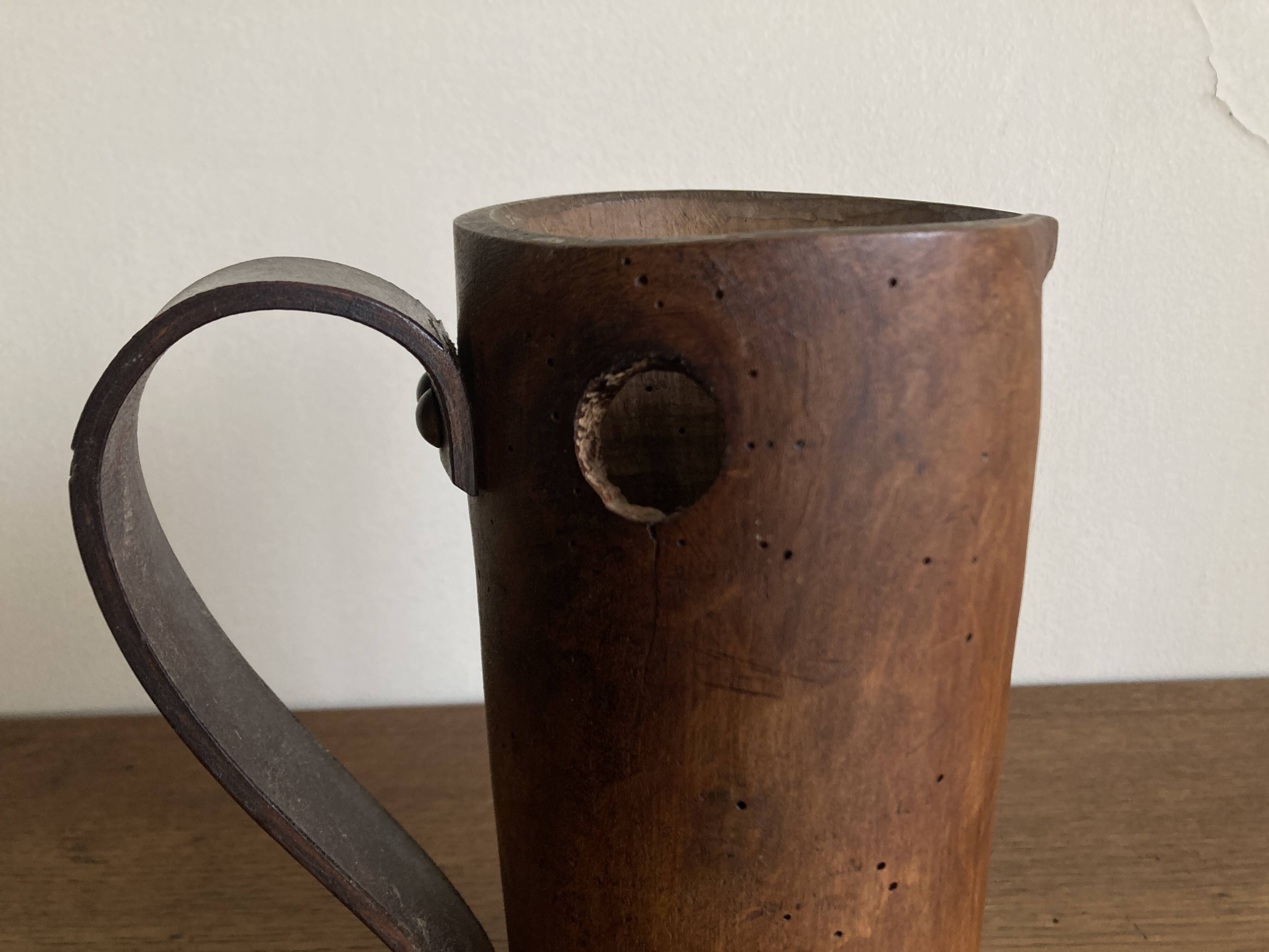 Mountain pitcher in monoxile wood and leather folk art