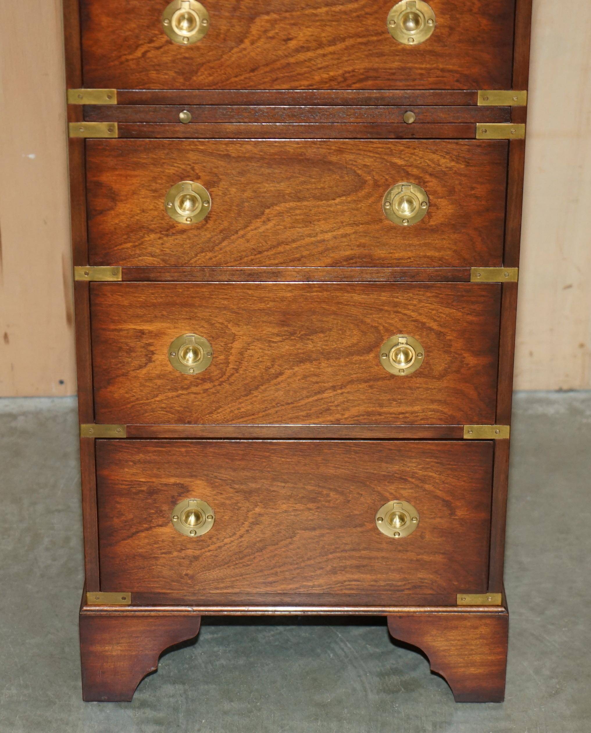 Pair of vintage military campaign high chests of drawers with leather tops.