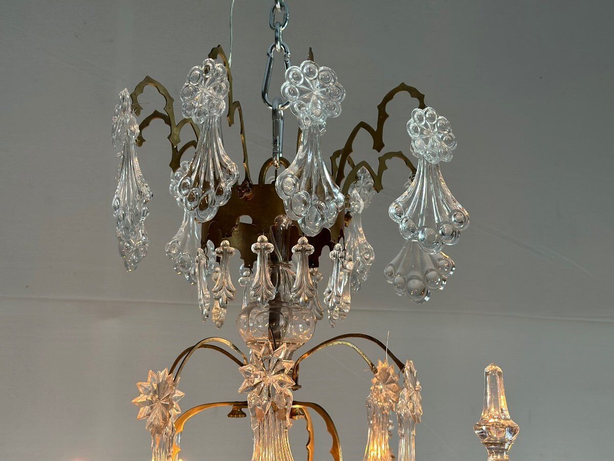 Bronze cage chandelier adorned with molded glass pendants in the shape of peacock feathers, circa 1800