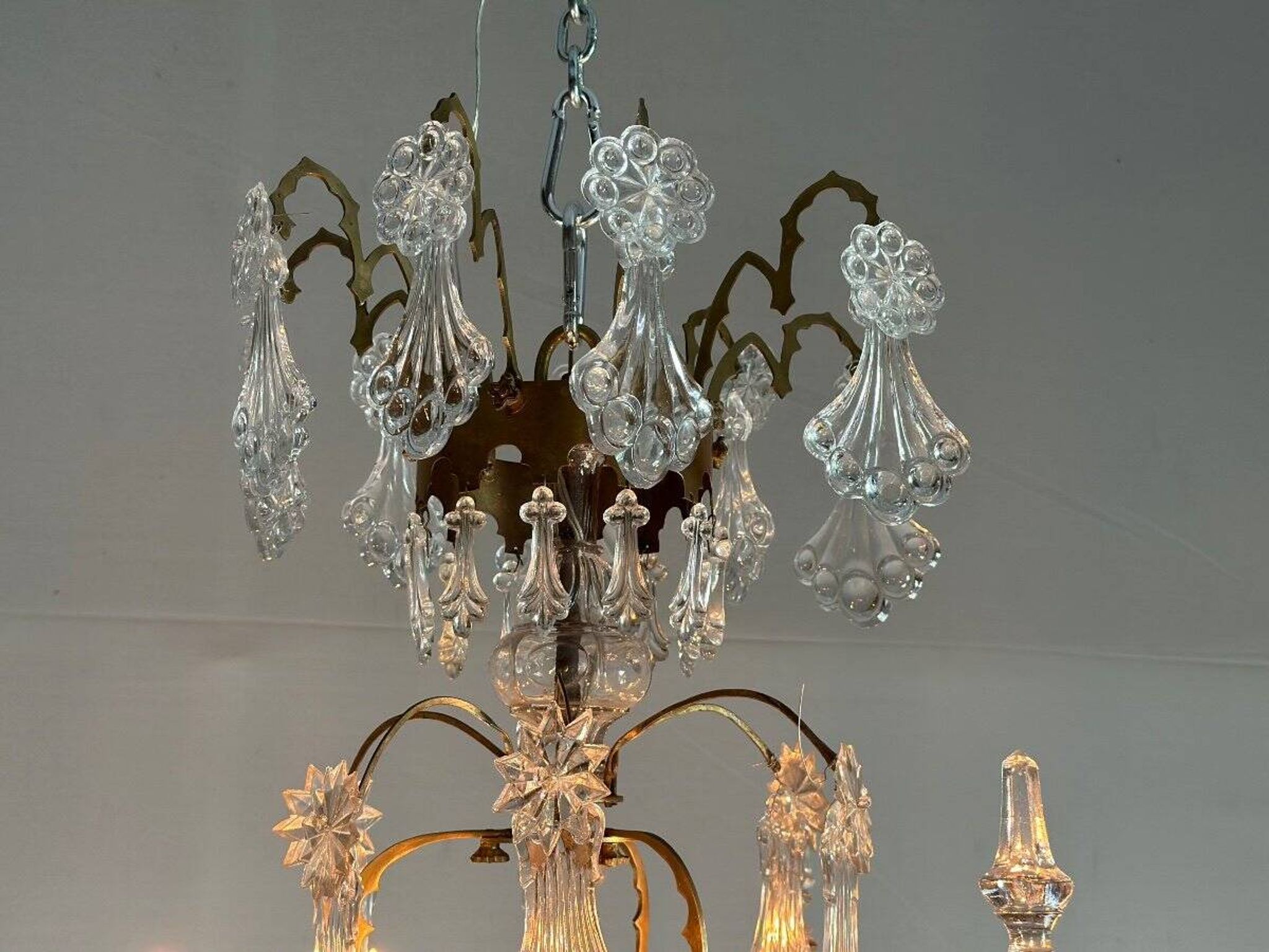 Bronze cage chandelier adorned with molded glass pendants in the shape of peacock feathers, circa 1800