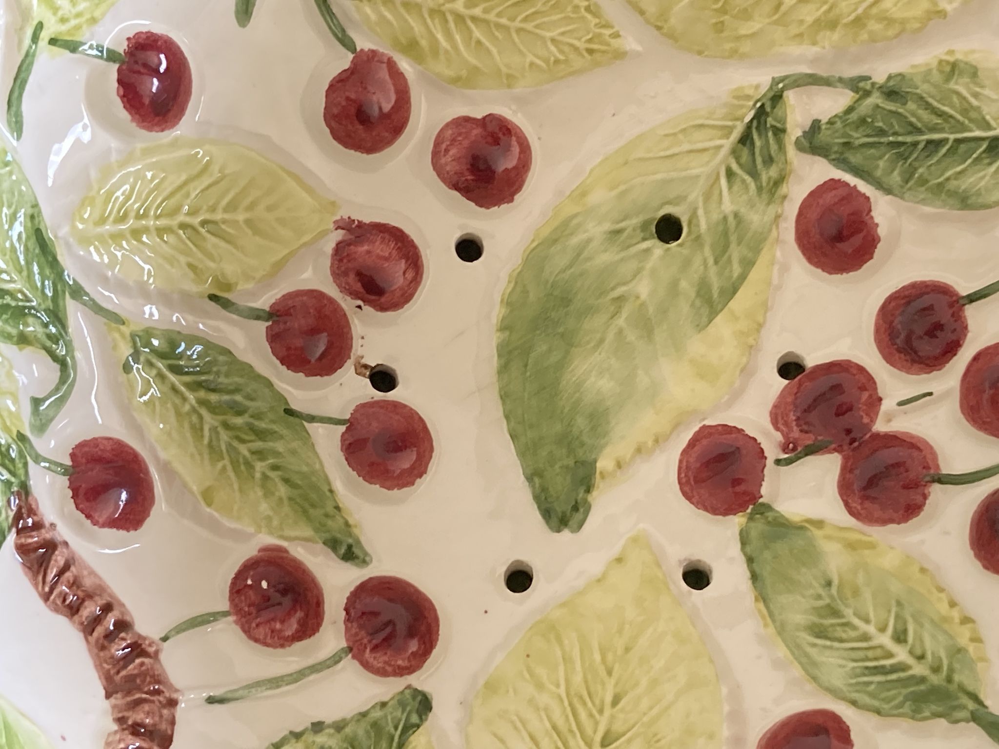 Cherry-decorated drainer fruit cup with its leaf-shaped dish