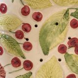 Cherry-decorated drainer fruit cup with its leaf-shaped dish