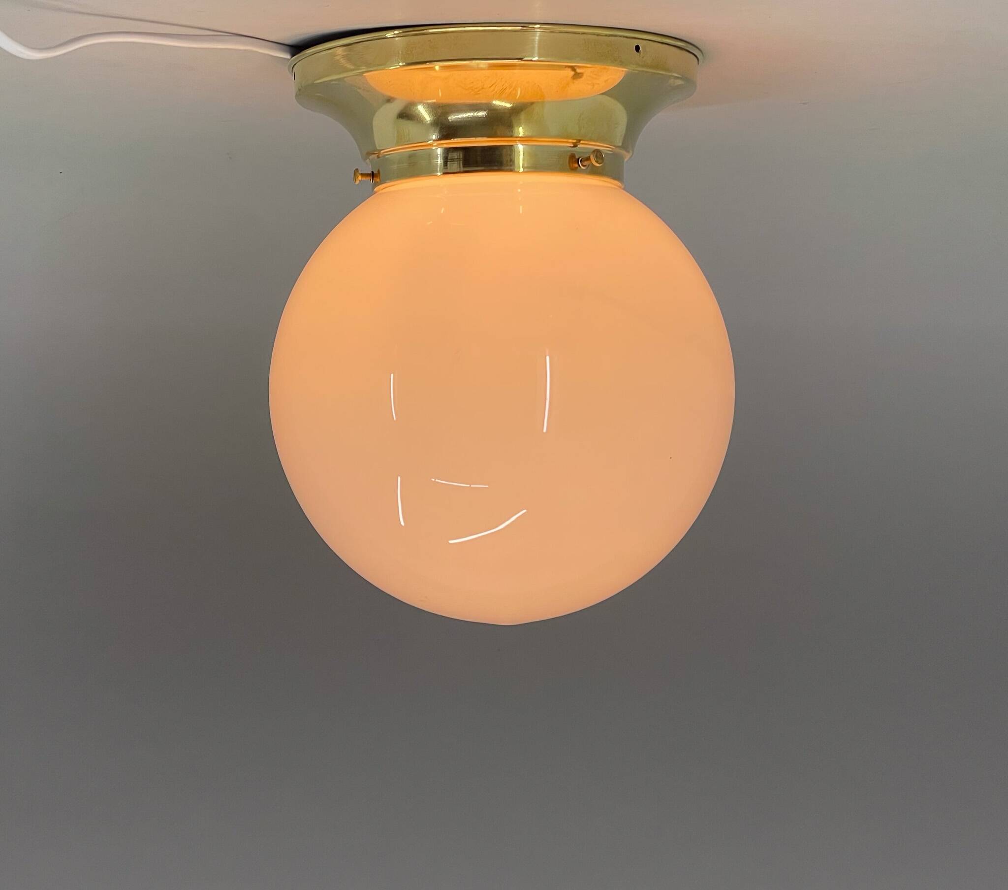 Set of three mid-century brass and milk glass ceiling ligts, restored