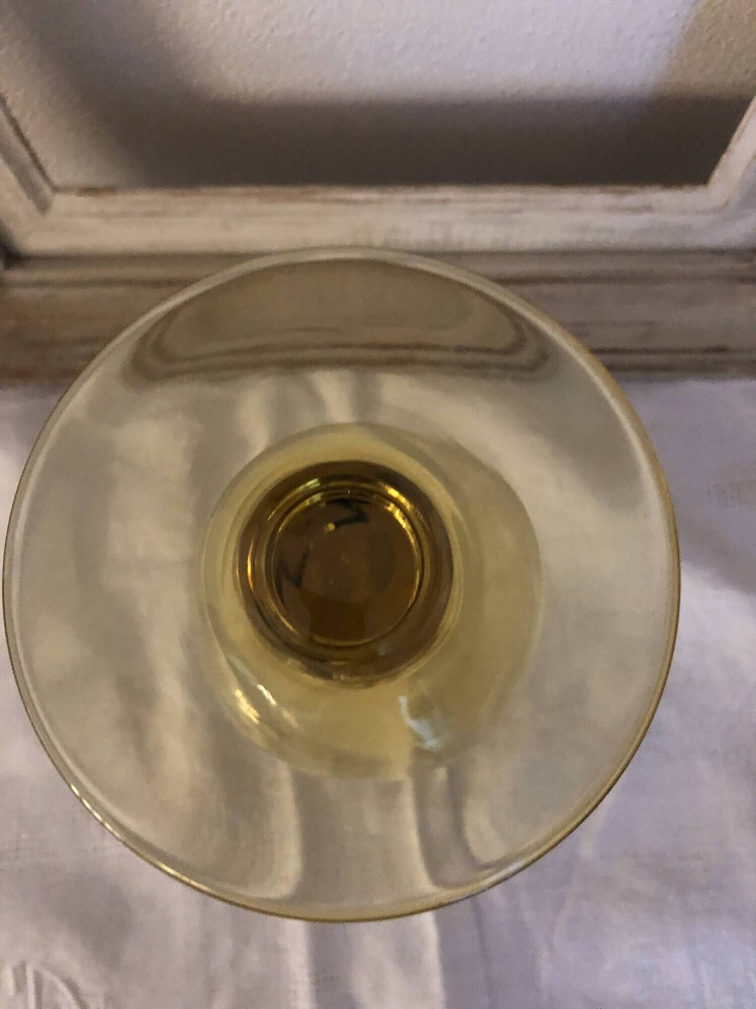 Yellow chalice vase, yellow glass vase on a pedestal.