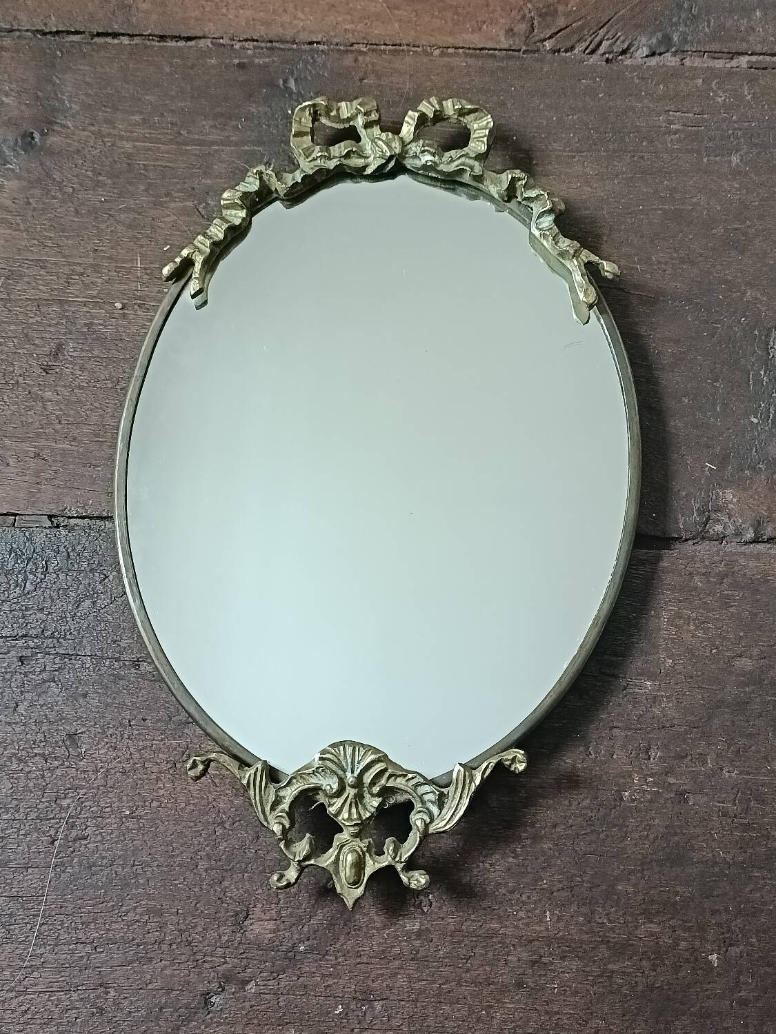 Antique mirror, oval with brass crest