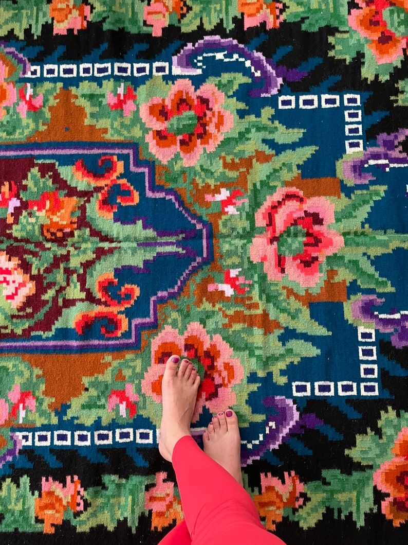 Rug with floral design on a blue background made by hand in Romania