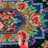 Rug with floral design on a blue background made by hand in Romania