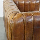 Cognac-colored cowhide 2-seater designer sofa finished with piping
