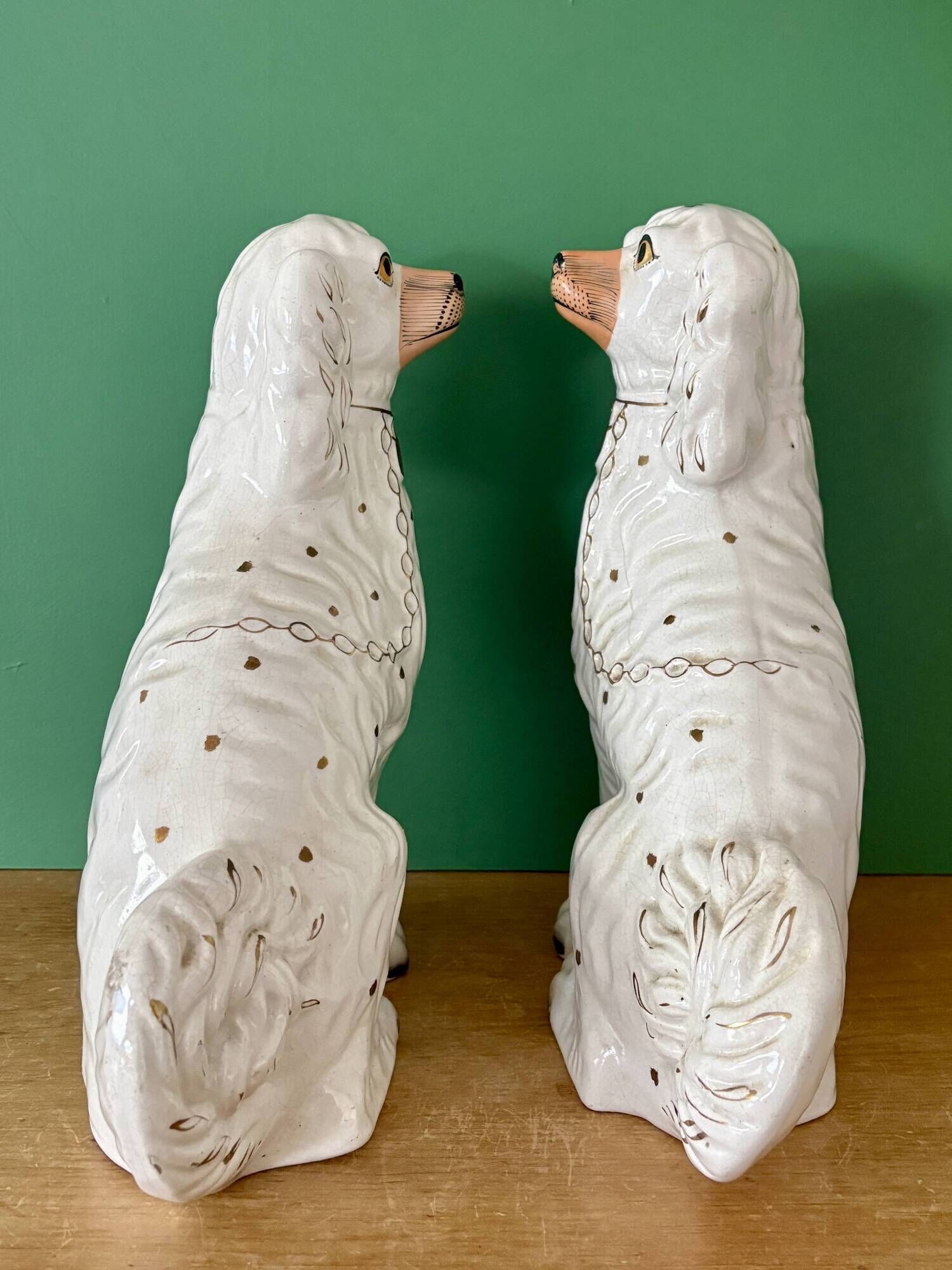 Pair of Staffordshire-type dogs in white and gold ceramic