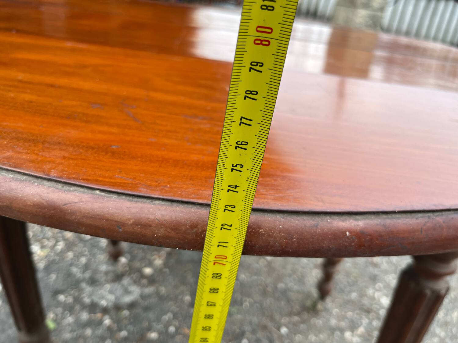 Antique round mahogany table, turned and fluted legs