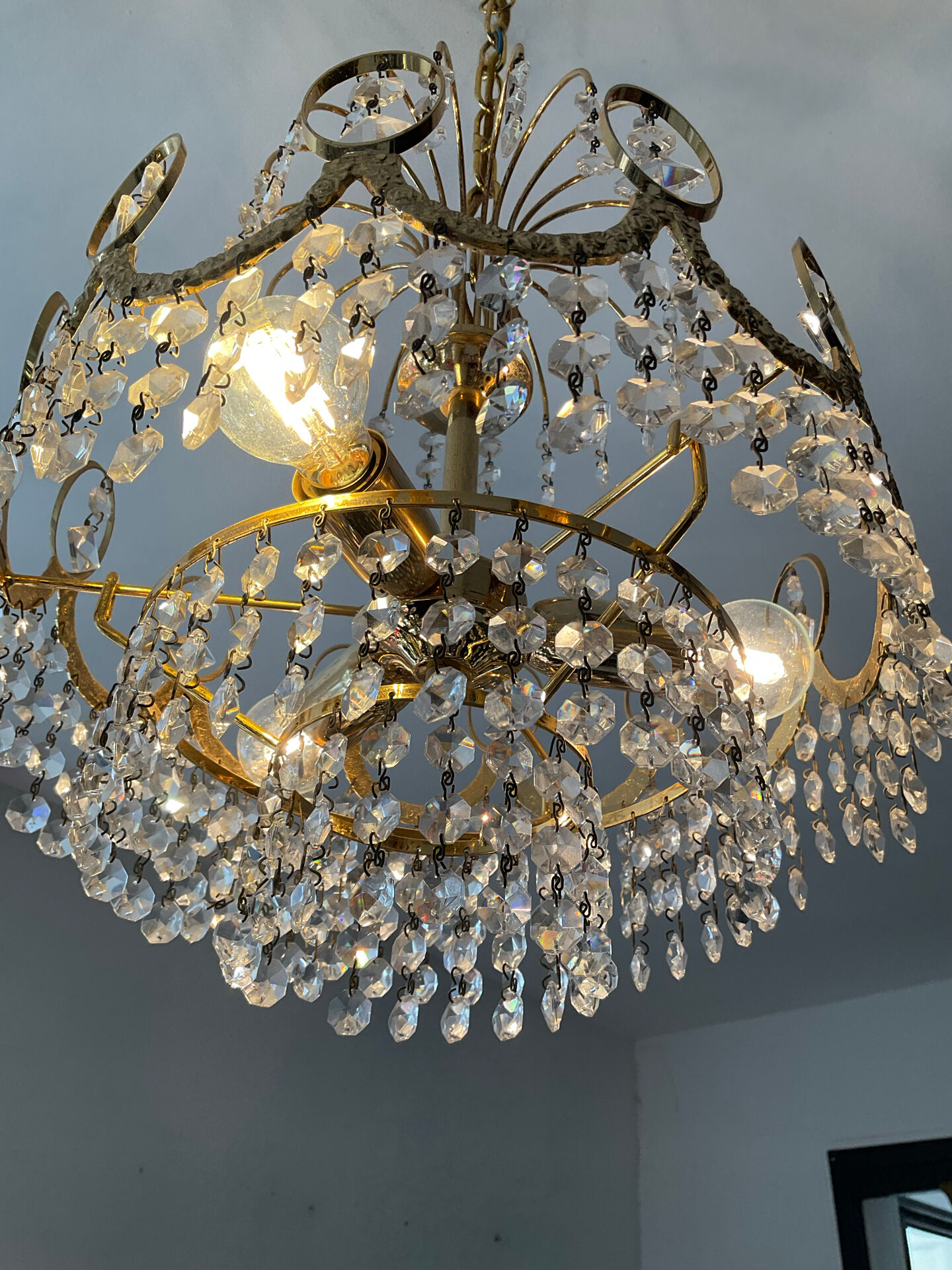 Brass chandelier with crystal pendants from the 1970s.