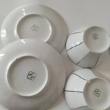 Two Art Deco porcelain cups and saucers with silver trim.