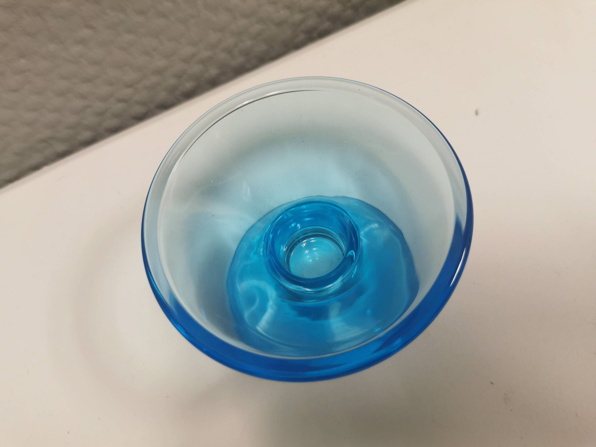 Two small candle holders in blue glass from the well-known Finnish company Ittala.
