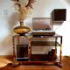 Service table with vintage brass wheels / smoked glass