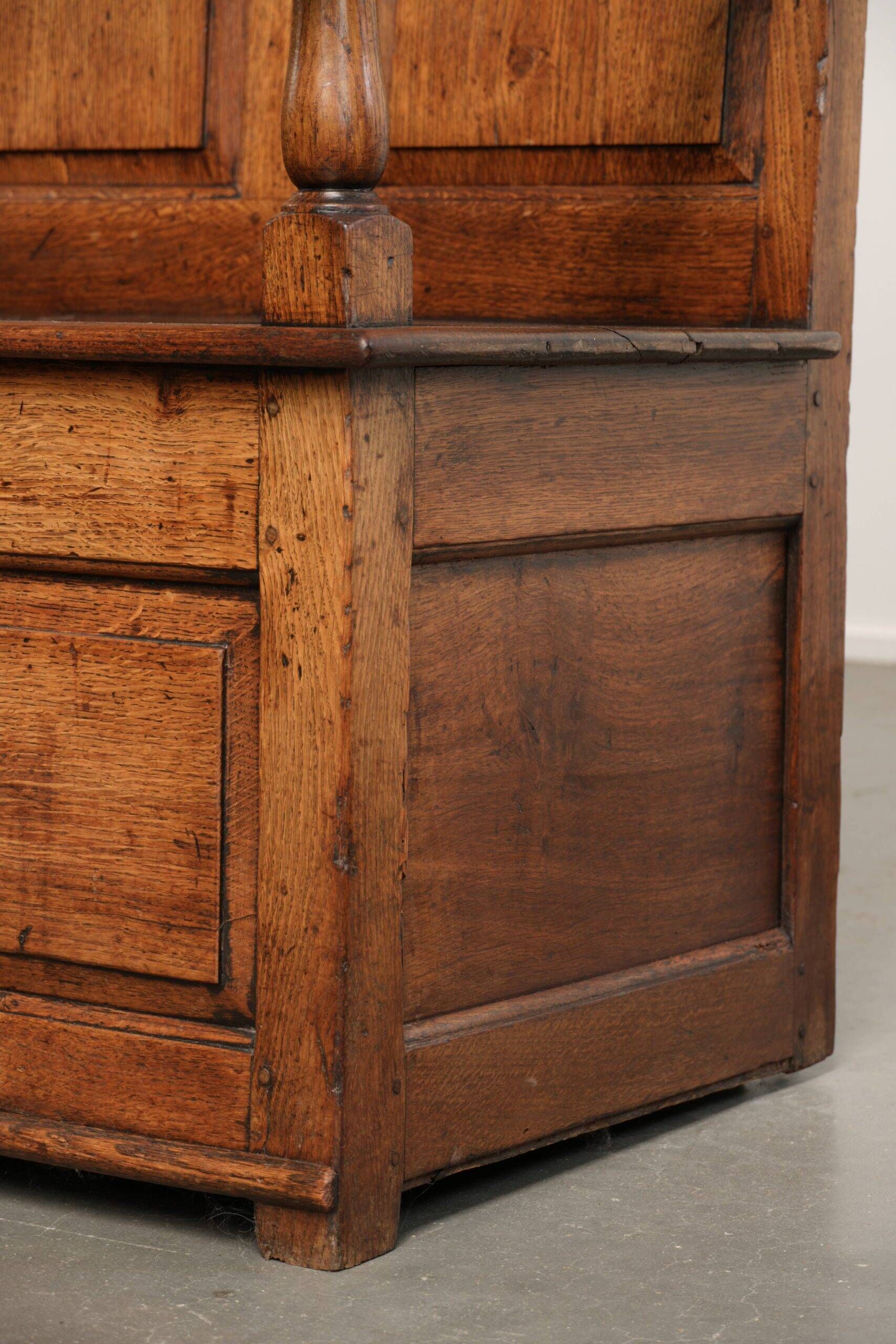 Antique English oak hall bench from the early 19th century with storage space
