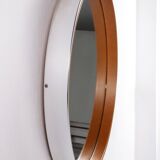 Round mirror covered with leather and chrome, made in France in the 1970s.
