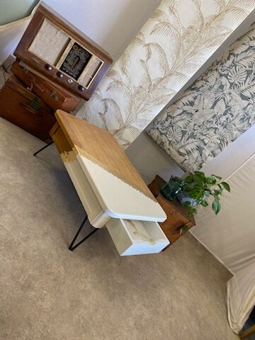 Coffee table with pin legs and gold leaf