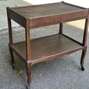 Extendable wooden bar trolley with a glass top from the 1930s.