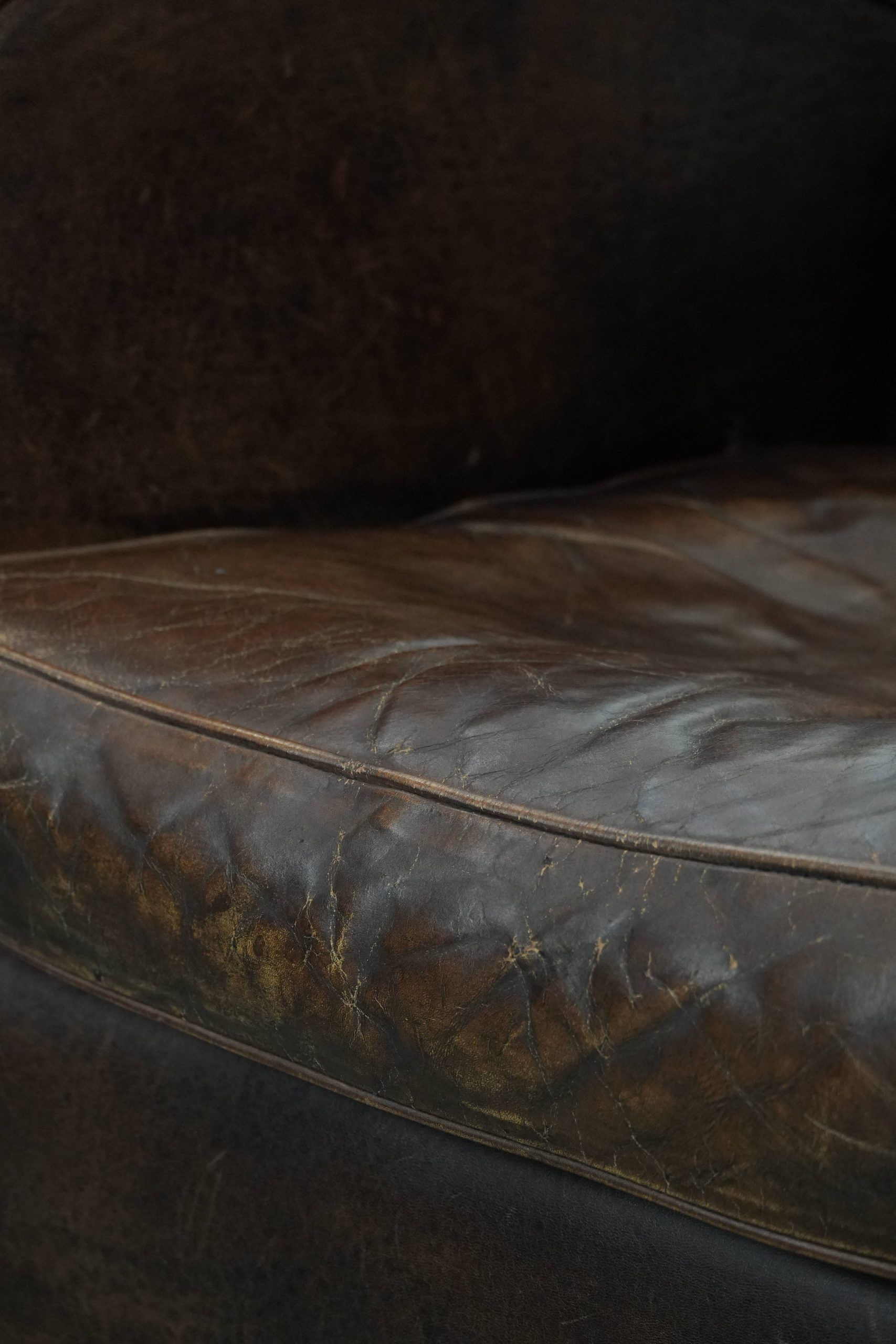 Set of two vintage sheepskin leather design armchairs in a cognac colour