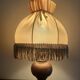 Pair of wooden bedside lamps with vintage fringe lampshades.