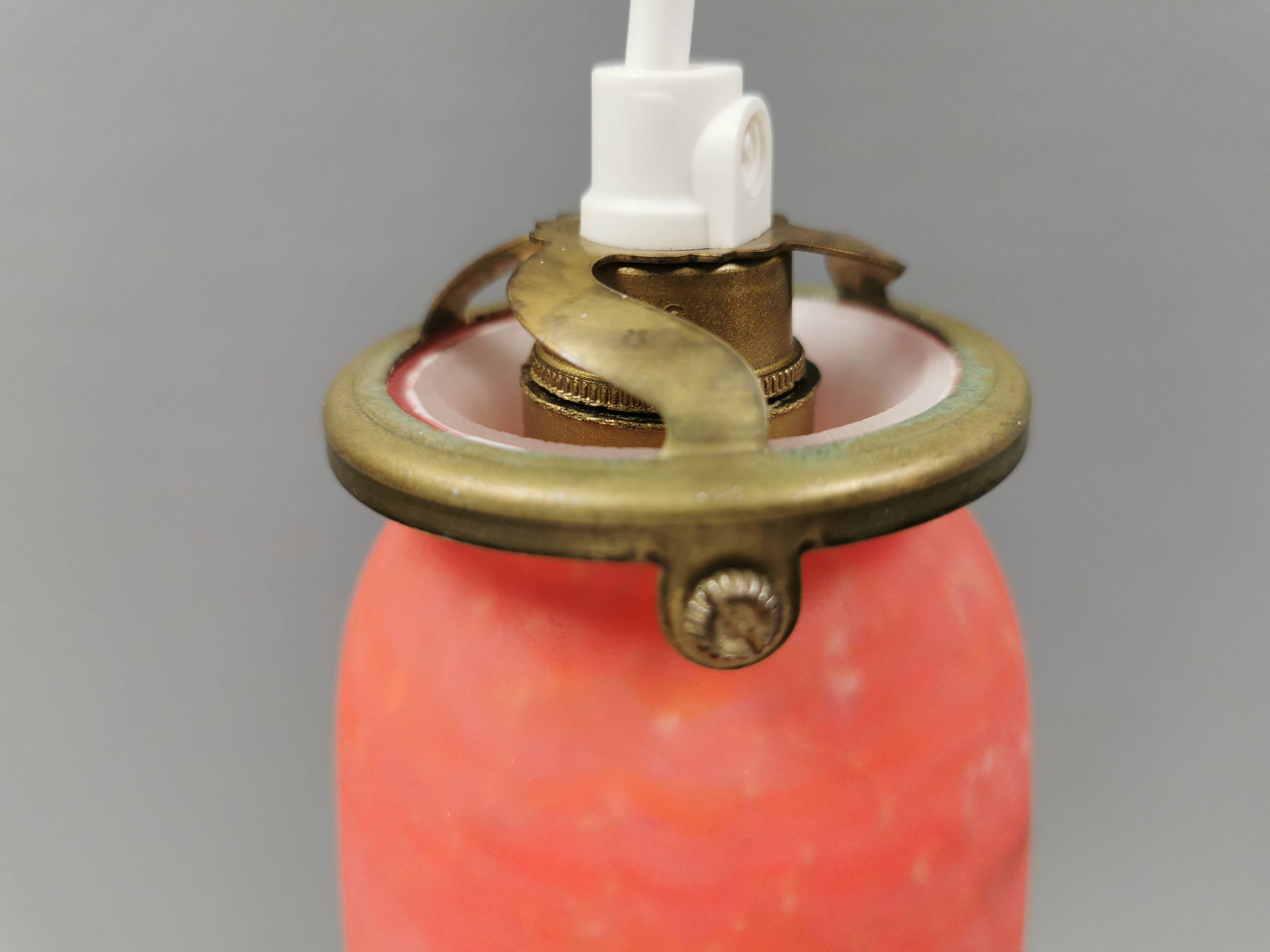 Small, beautiful hanging lamp in Art Deco style with brass top.