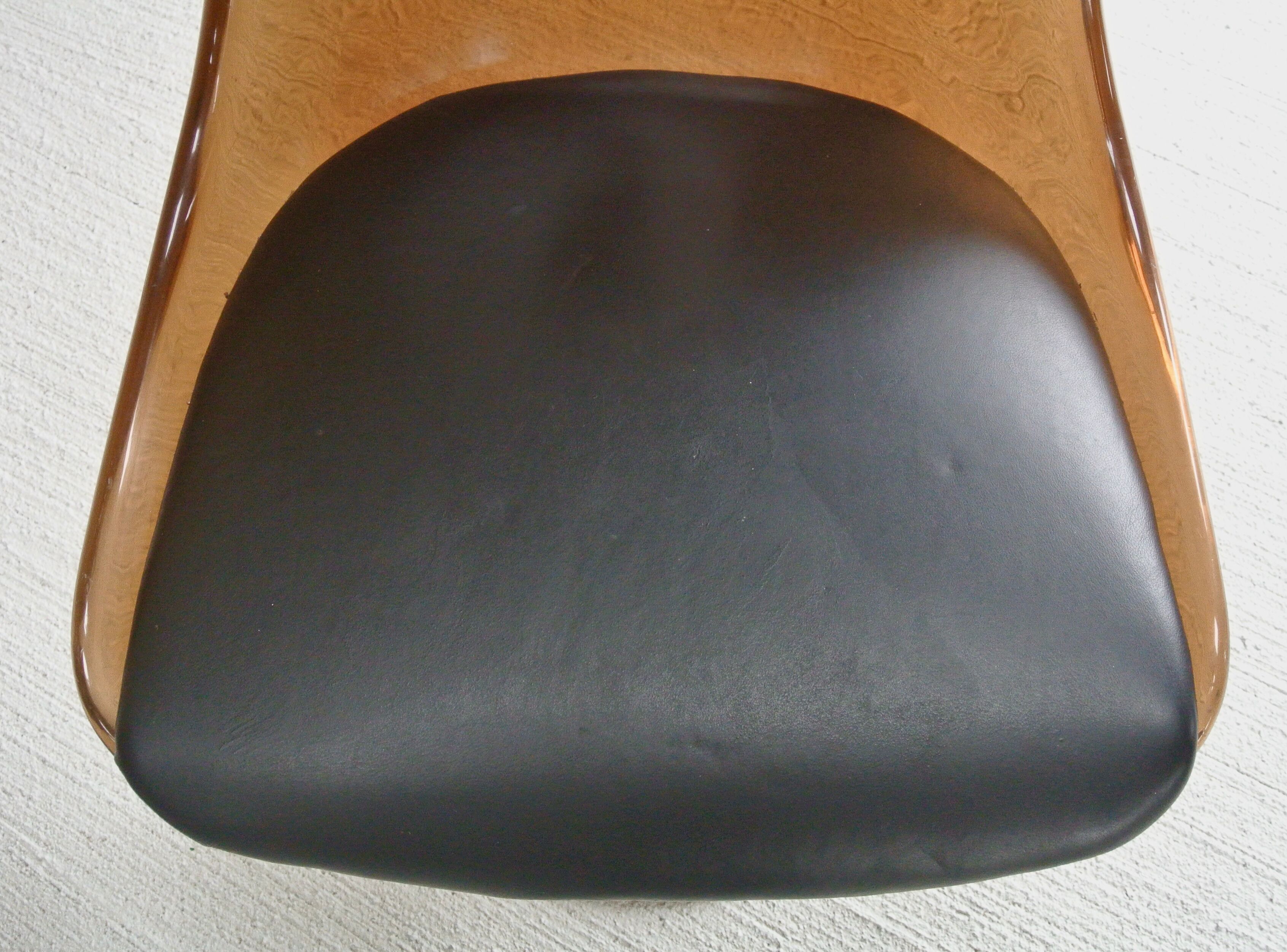 Four swivel chairs - metal base - smoked brown plexi shell - black skaï seat