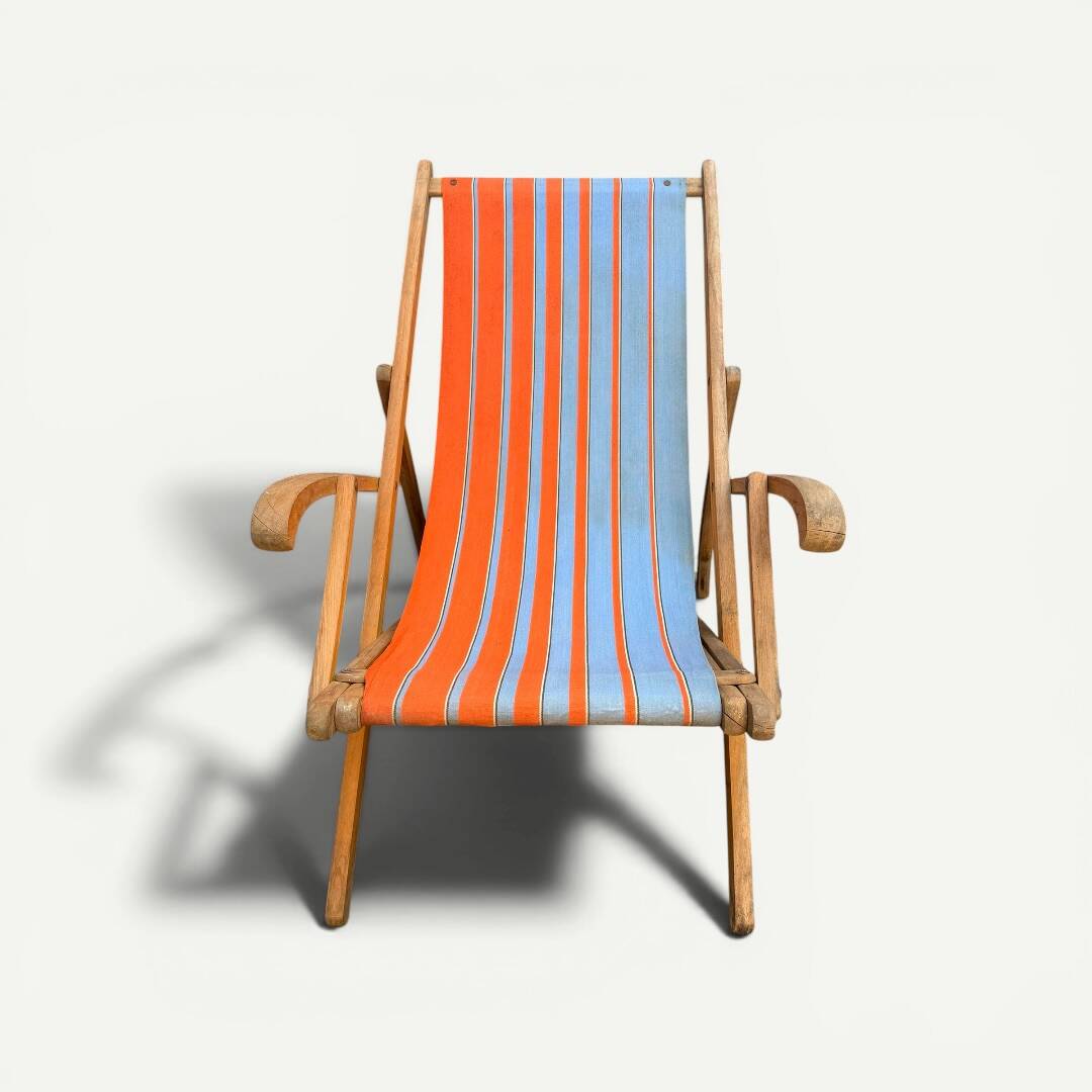 Vintage deck chair with orange and blue striped fabric, original patina.