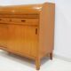 Modern Scandinavian wardrobe in teak with sliding doors and drop-down flap.