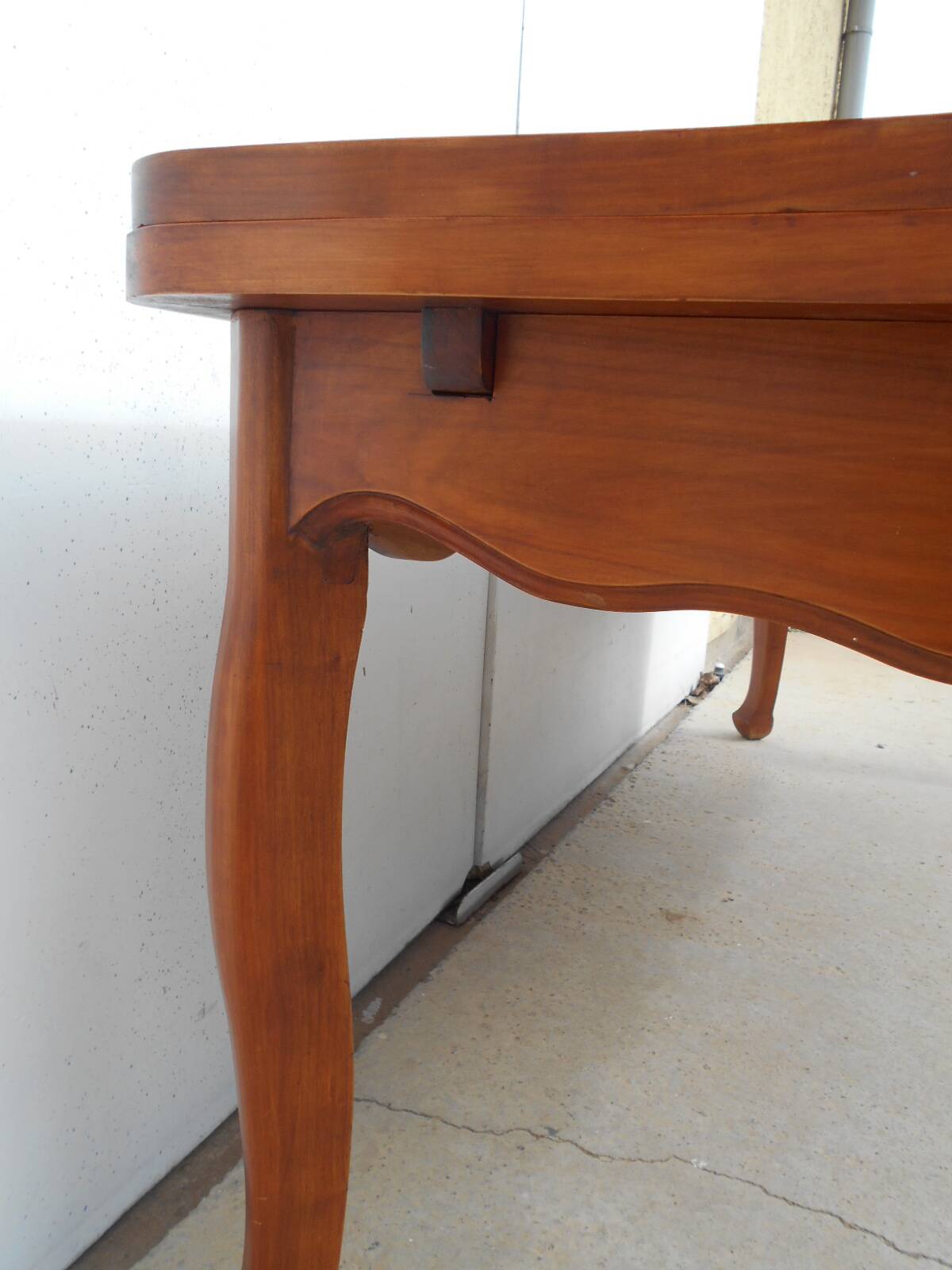 Large solid wood table with integrated extensions.