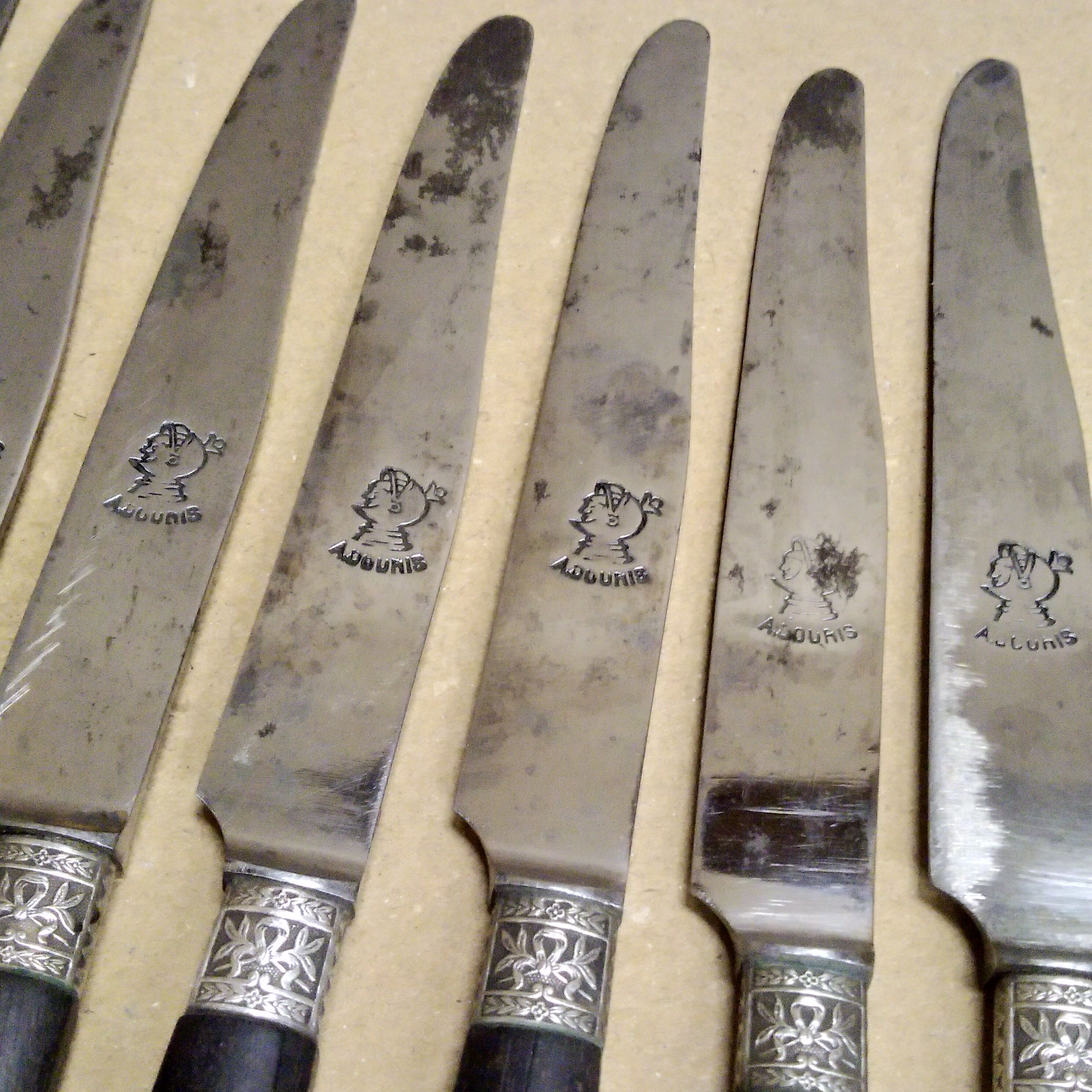 12 Silver dessert knives, ebony, steel, late 19th century